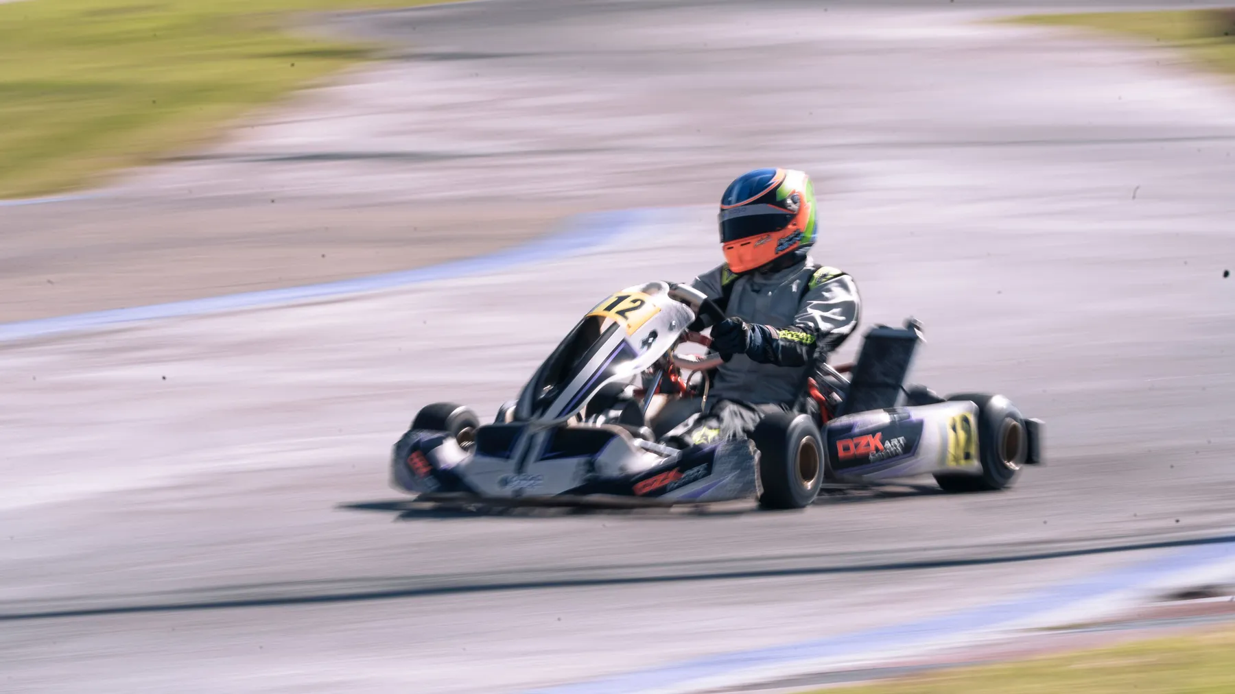 A racing kart at speed on a track